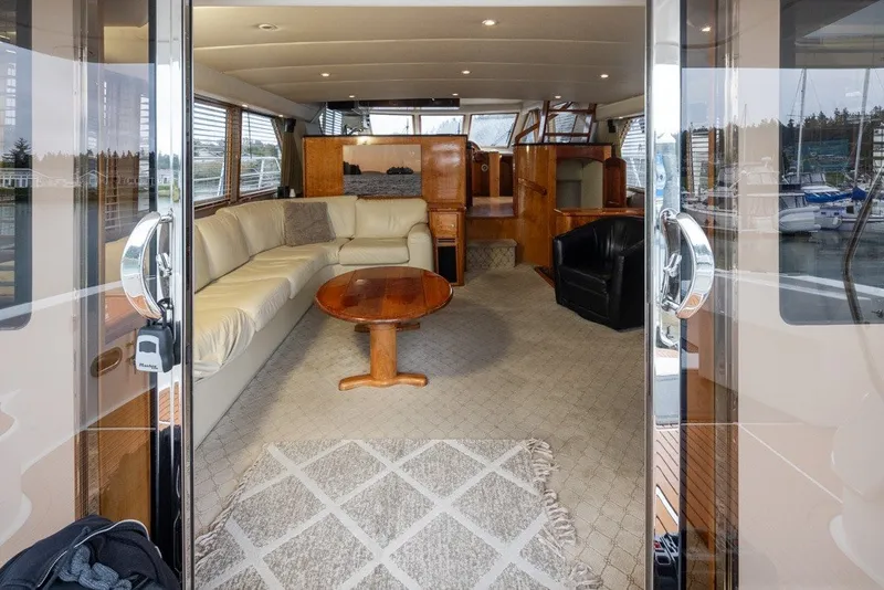 Slide: The Image of Luxurious interior of a 2004 Navigator Pilothouse yacht with plush seating and wooden accents. - 7