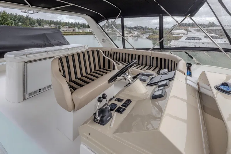 Slide: The Image of 2004 Navigator Pilothouse yacht interior with striped seating and control panel. - 38
