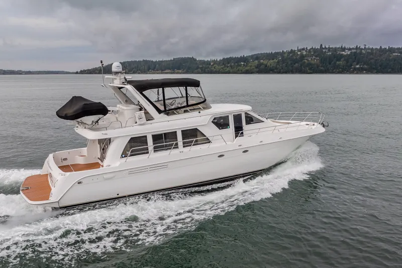 Slide: The Image of 2004 Navigator Pilothouse yacht cruising on a calm lake under cloudy skies. - 47