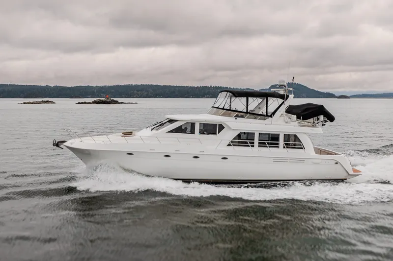 Slide: The Image of 2004 Navigator Pilothouse yacht cruising on a cloudy day in open waters. - 50