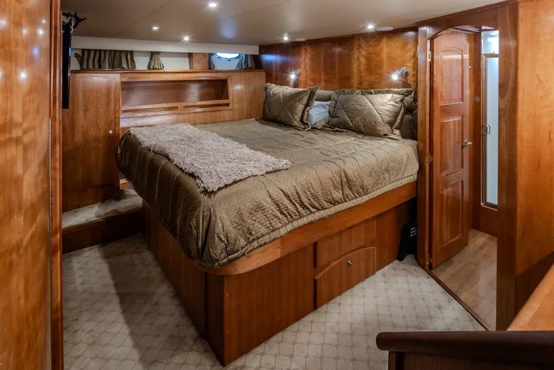 Slide: The Image of Luxurious 2004 Navigator Pilothouse bedroom with wood paneling and cozy bedding. - 21