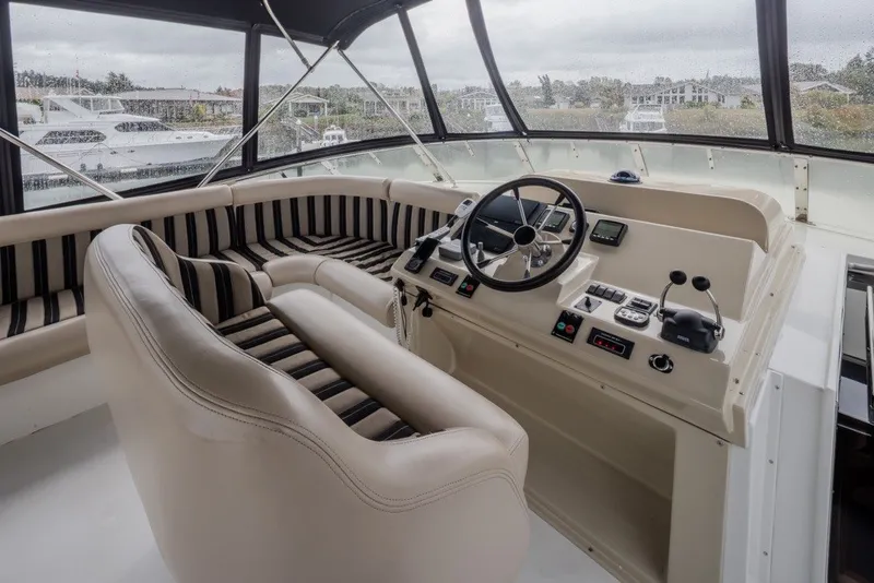 Slide: The Image of 2004 Navigator Pilothouse interior with steering wheel, controls, and striped seating. - 39