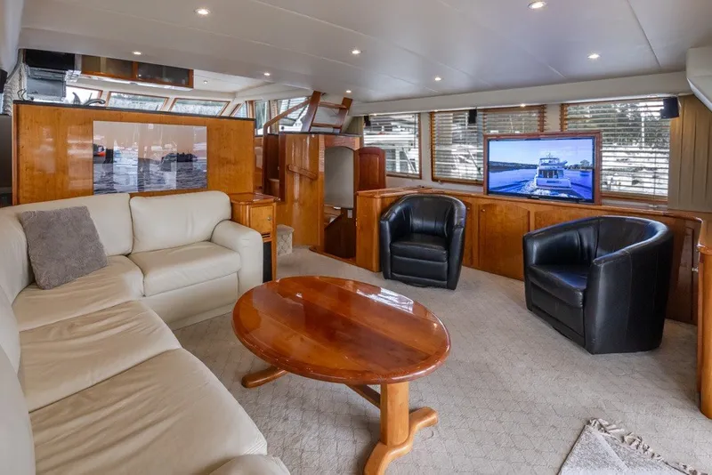 Slide: The Image of Luxurious 2004 Navigator Pilothouse yacht interior with leather seating, wooden accents, and large windows. - 10