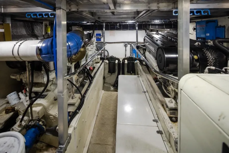 Slide: The Image of Engine room of a 2004 Navigator Pilothouse yacht, showcasing machinery and equipment. - 43