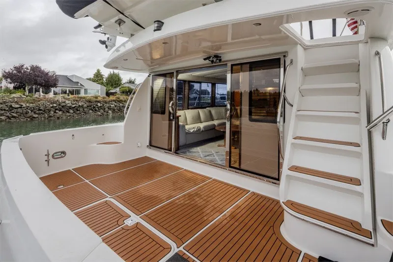 Slide: The Image of 2004 Navigator Pilothouse yacht with spacious deck and elegant interior view. - 5