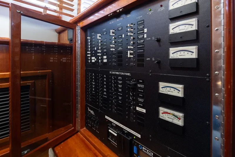 Slide: The Image of Electrical distribution panel in a 2004 Navigator Pilothouse yacht, featuring gauges and switches. - 33