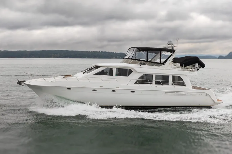 Slide: The Image of 2004 Navigator Pilothouse yacht cruising on a cloudy day, showcasing sleek design and elegance. - 4