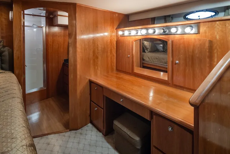 Slide: The Image of Luxurious wooden interior of a 2004 Navigator Pilothouse yacht with vanity and storage. - 23