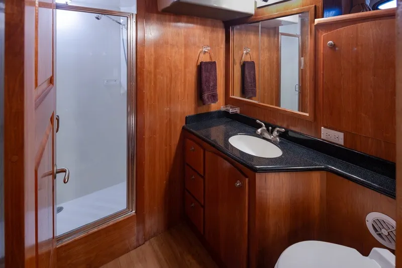 Slide: The Image of Luxurious 2004 Navigator Pilothouse bathroom with wood cabinetry and modern fixtures. - 24