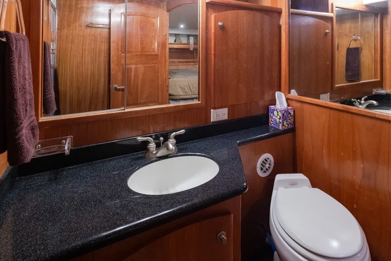 Slide: The Image of Luxurious 2004 Navigator Pilothouse bathroom with wood cabinetry and modern fixtures. - 31