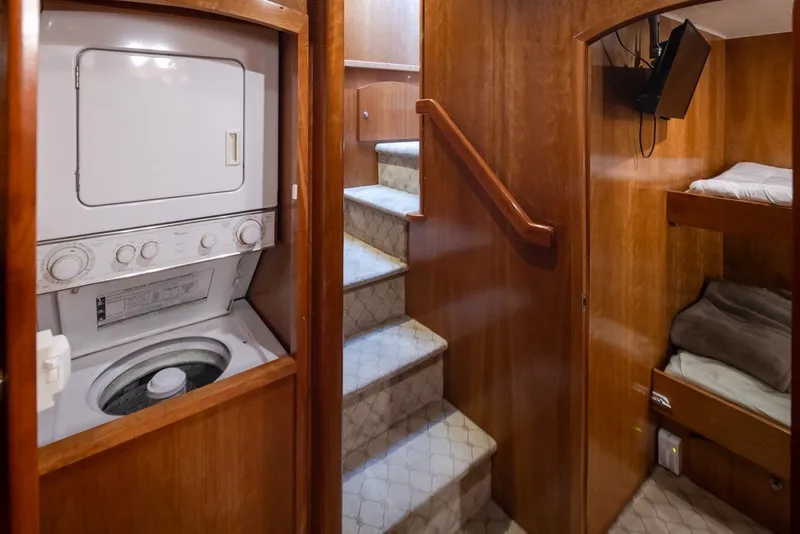 Slide: The Image of 2004 Navigator Pilothouse interior with washer, stairs, and bunk beds. - 19
