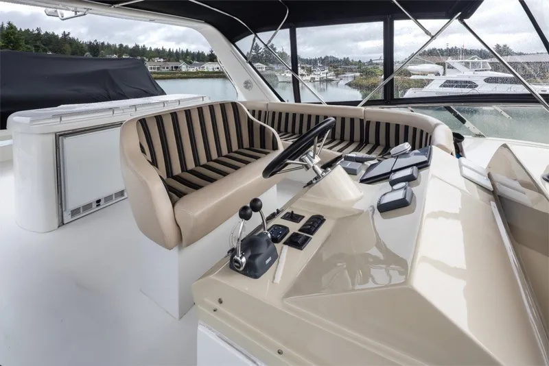 Slide: The Image of Luxurious 2004 Navigator Pilothouse yacht interior with striped seating and modern helm controls. - 34