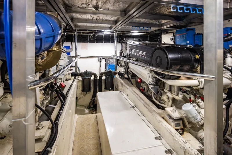 Slide: The Image of Engine room of a 2004 Navigator Pilothouse yacht, showcasing machinery and equipment. - 44