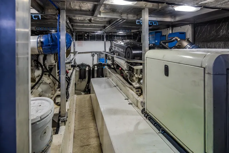 Slide: The Image of Engine room of a 2004 Navigator Pilothouse yacht, showcasing machinery and equipment. - 42