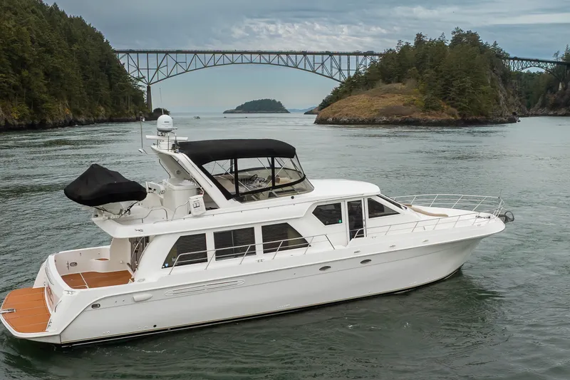 Slide: The Image of 2004 Navigator Pilothouse yacht cruising near scenic bridge and lush islands. - 3
