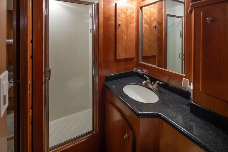 Slide: The Image of Luxurious 2004 Navigator Pilothouse bathroom with wood cabinetry and modern fixtures. - 26