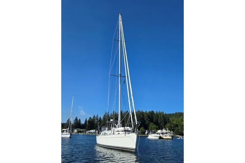 Slide: The Image of Sailboat on calm water, Outbound 46 model, 2014, under clear blue sky. - 56
