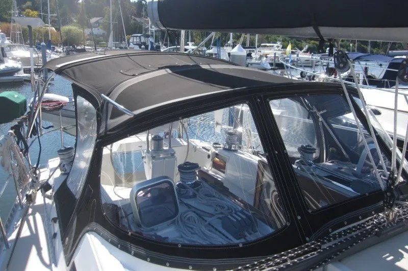 Slide: The Image of 2014 Outbound 46 sailboat with black canopy docked at marina. - 44