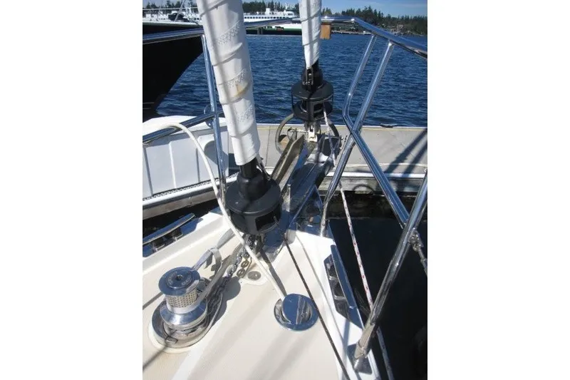 Slide: The Image of Sailboat deck of 2014 Outbound 46, featuring winches and rigging near the water. - 39
