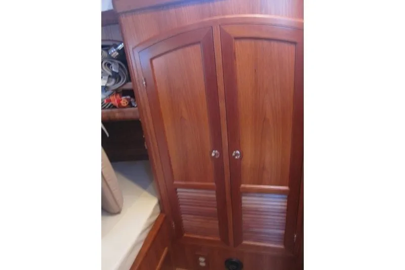 Slide: The Image of Wooden cabinet interior of 2014 Outbound 46 yacht, featuring elegant design and craftsmanship. - 15