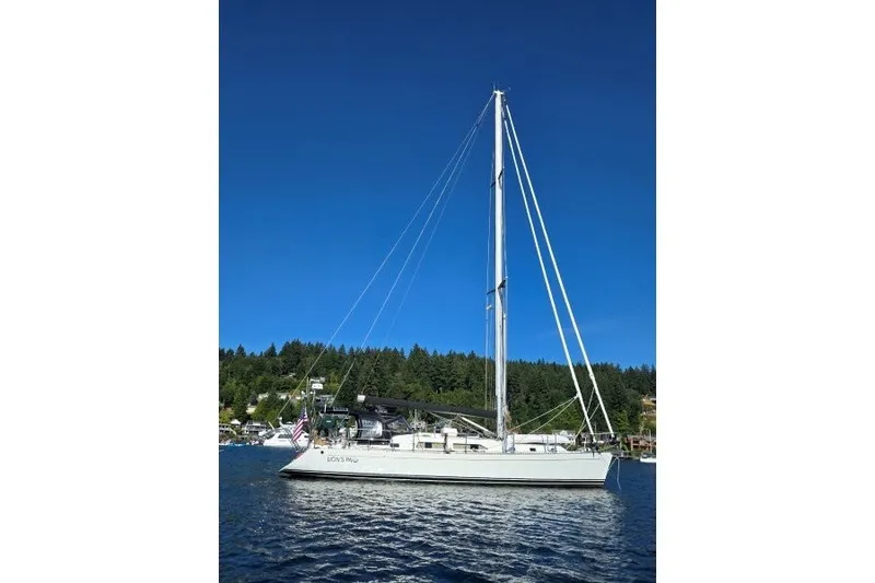 Slide: The Image of Sailboat on calm water, Outbound 46 model, 2014, under clear blue sky. - 55