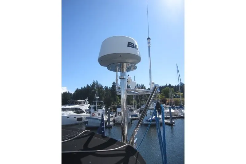 Slide: The Image of Radar equipment on 2014 Outbound 46 yacht docked at marina under clear blue sky. - 45