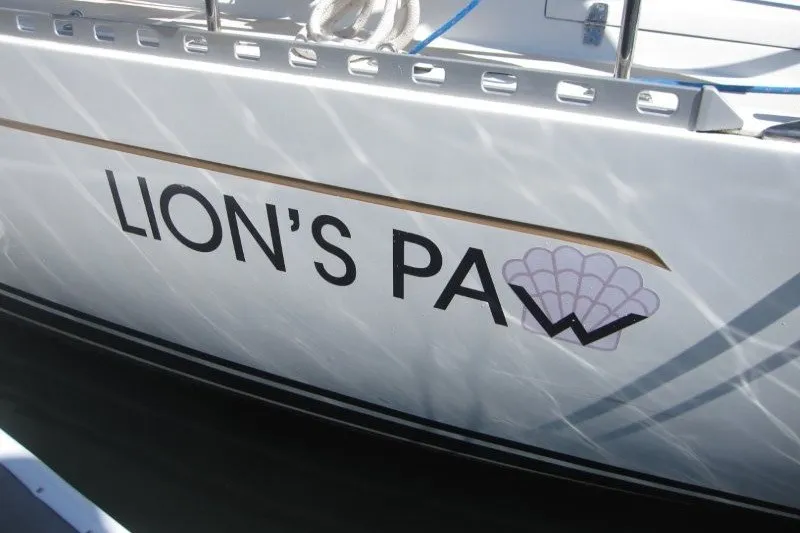 Slide: The Image of Sailboat named "Lion's Paw," Outbound 46, 2014 model, docked in sunlight. - 53