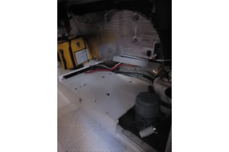Slide: The Image of Engine compartment of a 2014 Outbound 46 yacht, featuring wiring and equipment. - 19