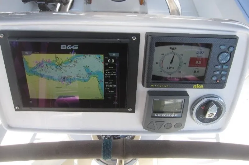 Slide: The Image of Navigation and control panel on a 2014 Outbound 46 yacht, featuring B&G and NKE displays. - 36