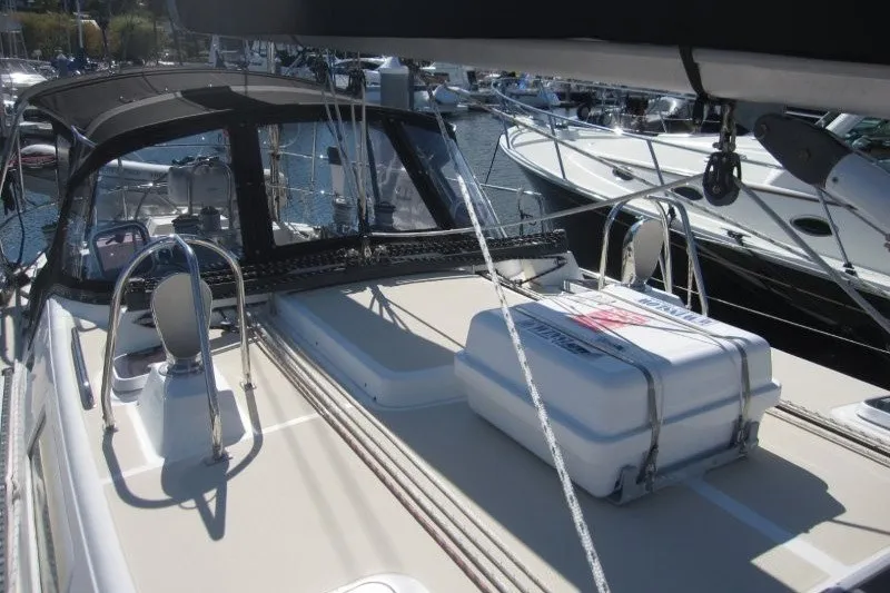 Slide: The Image of Sailboat deck of 2014 Outbound 46, featuring cockpit and lifeboat storage. - 43