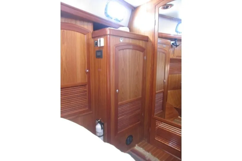 Slide: The Image of Interior of 2014 Outbound 46 yacht with wooden cabinetry and mirror. - 16
