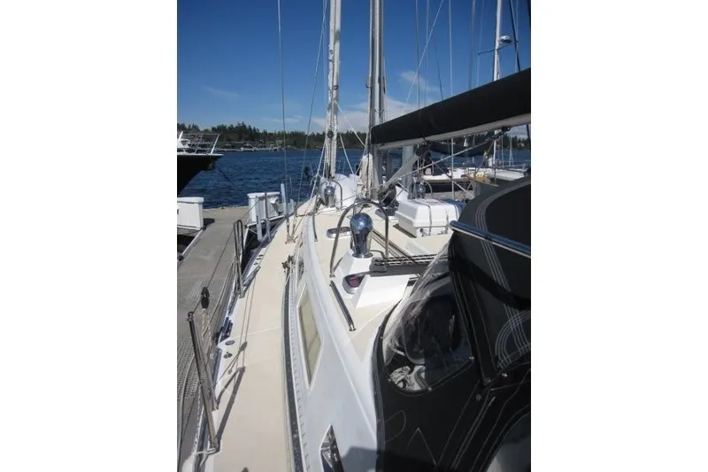 Slide: The Image of Sailboat docked at marina, Outbound 46 model, 2014, under clear blue sky. - 48