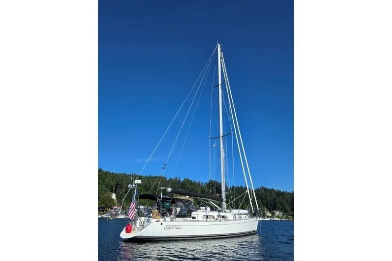 The Image of Sailboat "Outbound 46" from 2014 on calm water under clear blue sky. - 0