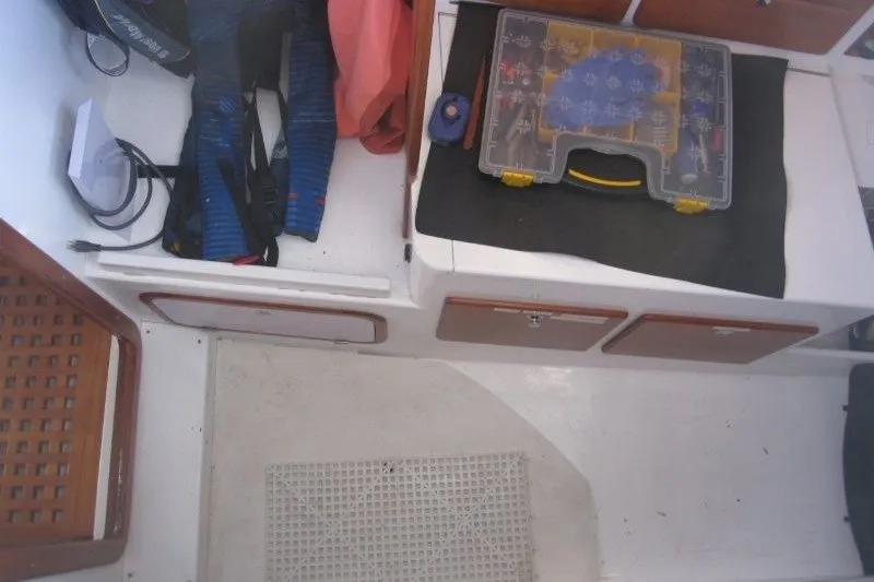 Slide: The Image of Interior of 2014 Outbound 46 sailboat with storage compartments and tool kit. - 34