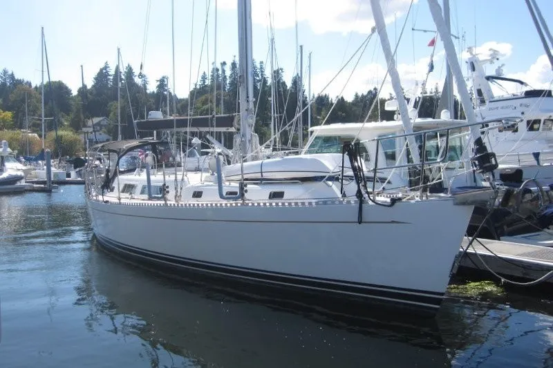 Slide: The Image of Sailboat docked in marina, 2014 Outbound 46 model, surrounded by other boats. - 51