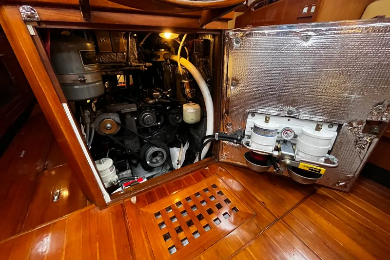 Slide: The Image of Engine compartment of a 1994 Hylas 49 yacht, showcasing mechanical components and insulation. - 30