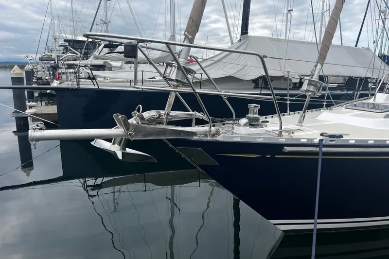 Slide: The Image of Sailboat Hylas 49, 1994 model, docked at marina with sleek design and polished anchor. - 34