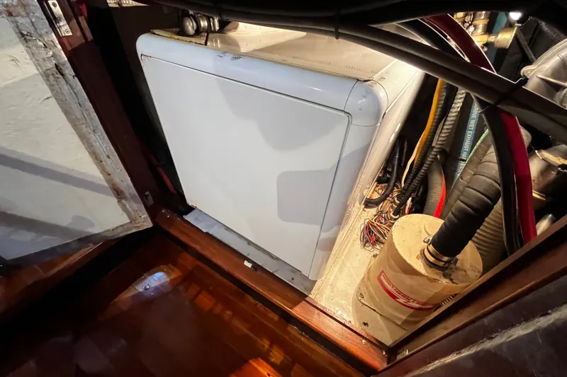 Slide: The Image of Engine room of a 1994 Hylas 49 yacht with visible machinery and wiring. - 29