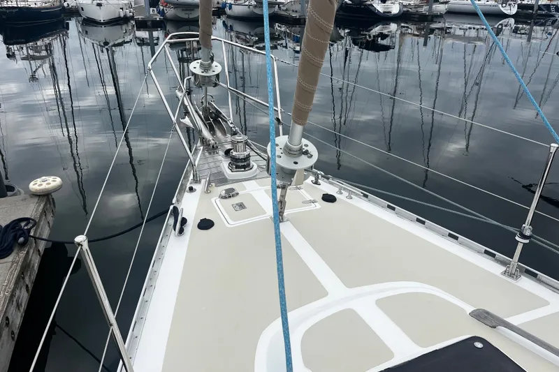 Slide: The Image of Sailboat deck of 1994 Hylas 49 docked in a marina, reflecting calm waters. - 39