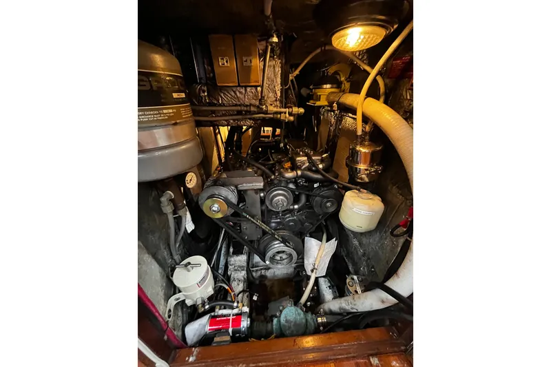 Slide: The Image of Engine room of a 1994 Hylas 49 yacht, showcasing mechanical components and lighting. - 31