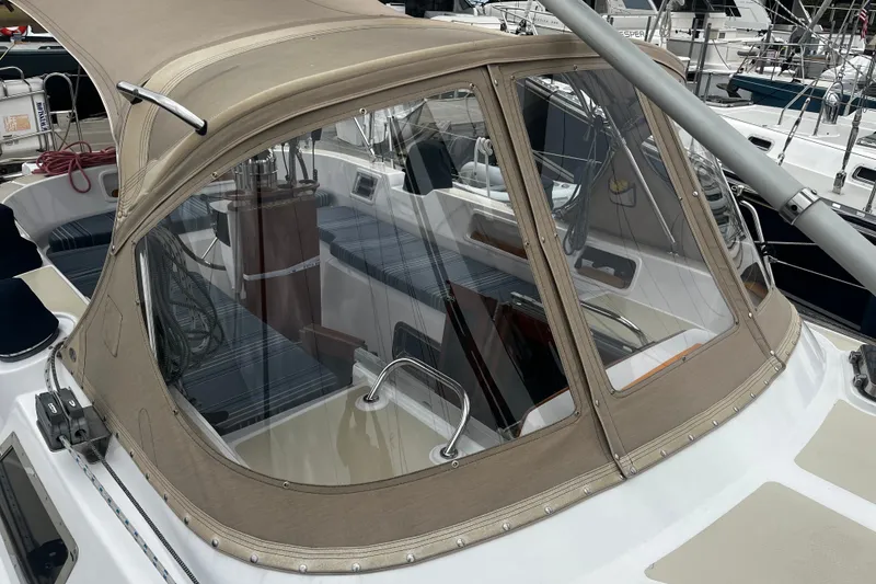 Slide: The Image of 1994 Hylas 49 sailboat cockpit with beige canopy and clear windows at marina. - 47