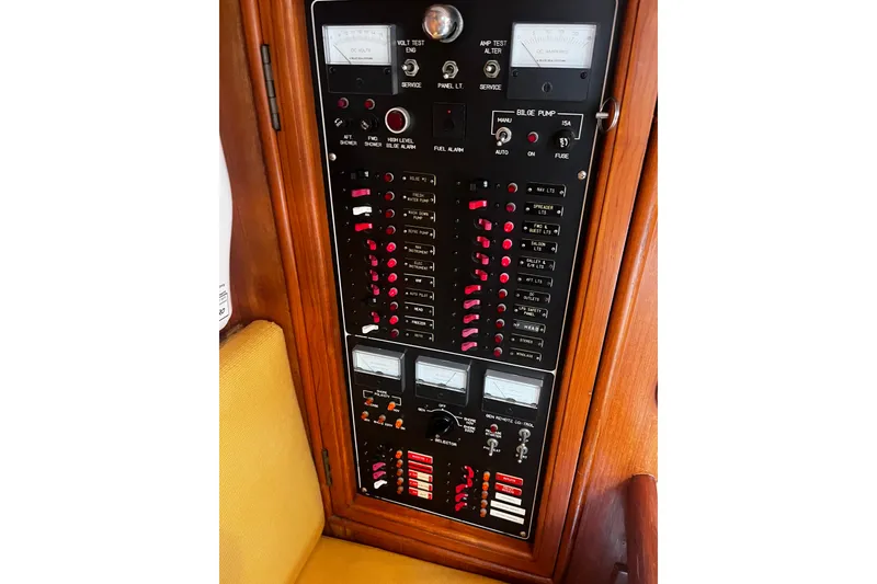 Slide: The Image of Electrical control panel on a 1994 Hylas 49 yacht, featuring gauges and switches. - 25