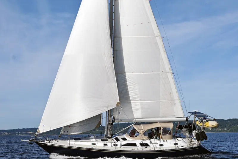 Slide: The Image of Sailing yacht Hylas 49 from 1994 gliding on open water under clear skies. - 67