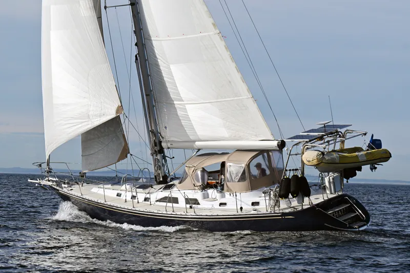 Slide: The Image of Sailing yacht Hylas 49 from 1994 on open water with full sails. - 68