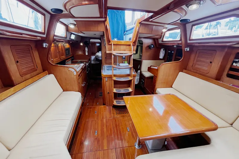 Slide: The Image of Luxurious 1994 Hylas 49 yacht interior with wooden finishes and comfortable seating. - 5