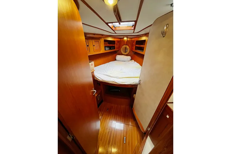 Slide: The Image of Cozy cabin interior of 1994 Hylas 49 yacht with wooden finishes and a comfortable bed. - 18