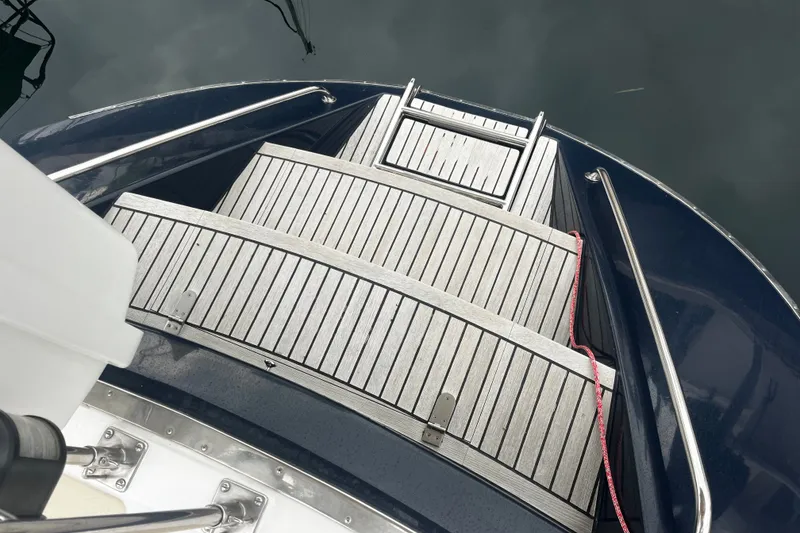 Slide: The Image of Stern view of 1994 Hylas 49 yacht with wooden steps and metal railings. - 64