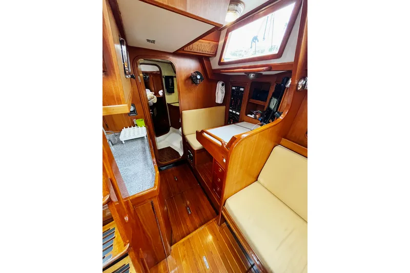Slide: The Image of Interior of a 1994 Hylas 49 yacht with wooden finishes and seating area. - 14