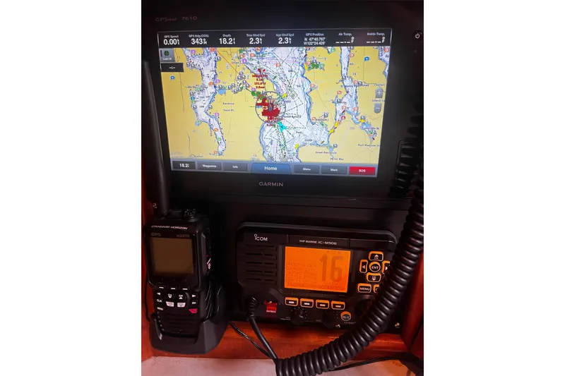 Slide: The Image of Navigation equipment on a 1994 Hylas 49 yacht, featuring Garmin GPS and Icom VHF radio. - 22