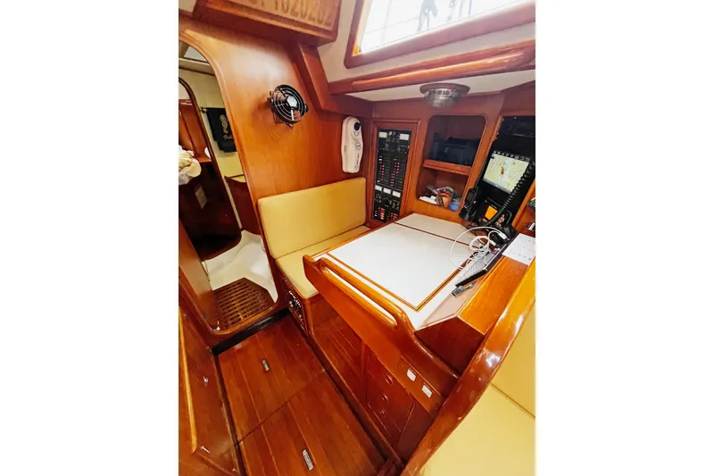 Slide: The Image of Interior of a 1994 Hylas 49 yacht with navigation station and wooden finish. - 15